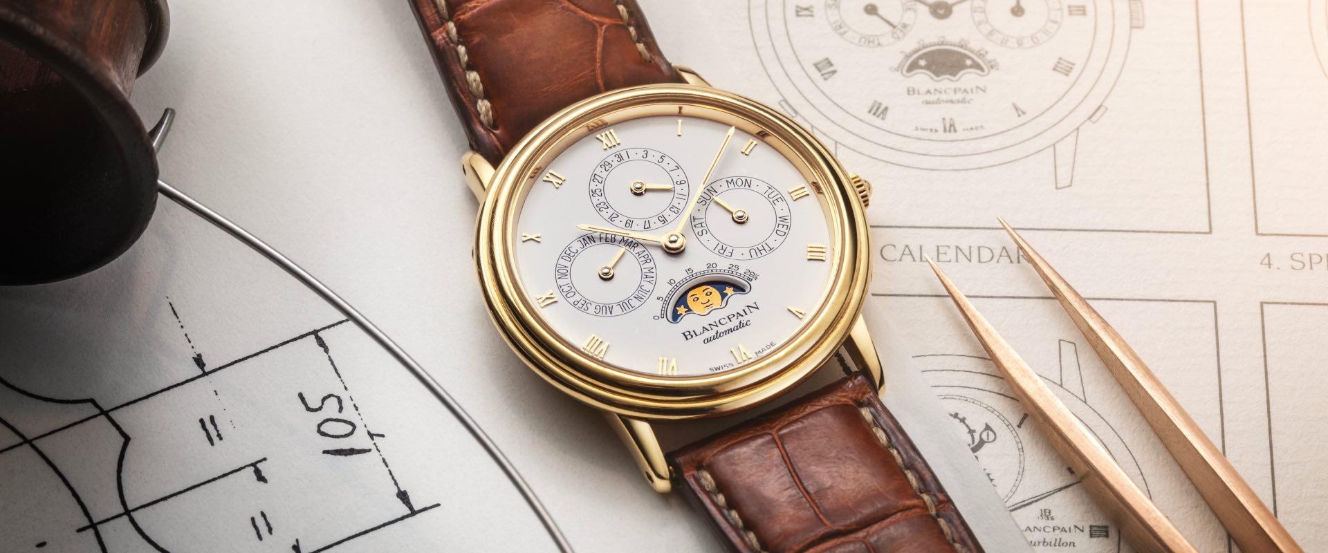 Blancpain Villeret complete calendar moon phase watch on leather strap, resting on architectural blueprints